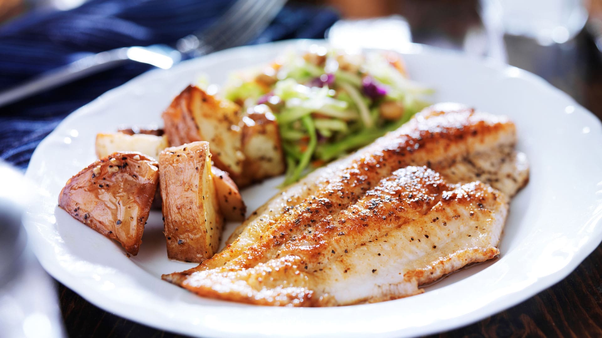 dinner with fish, salad, and potatoes